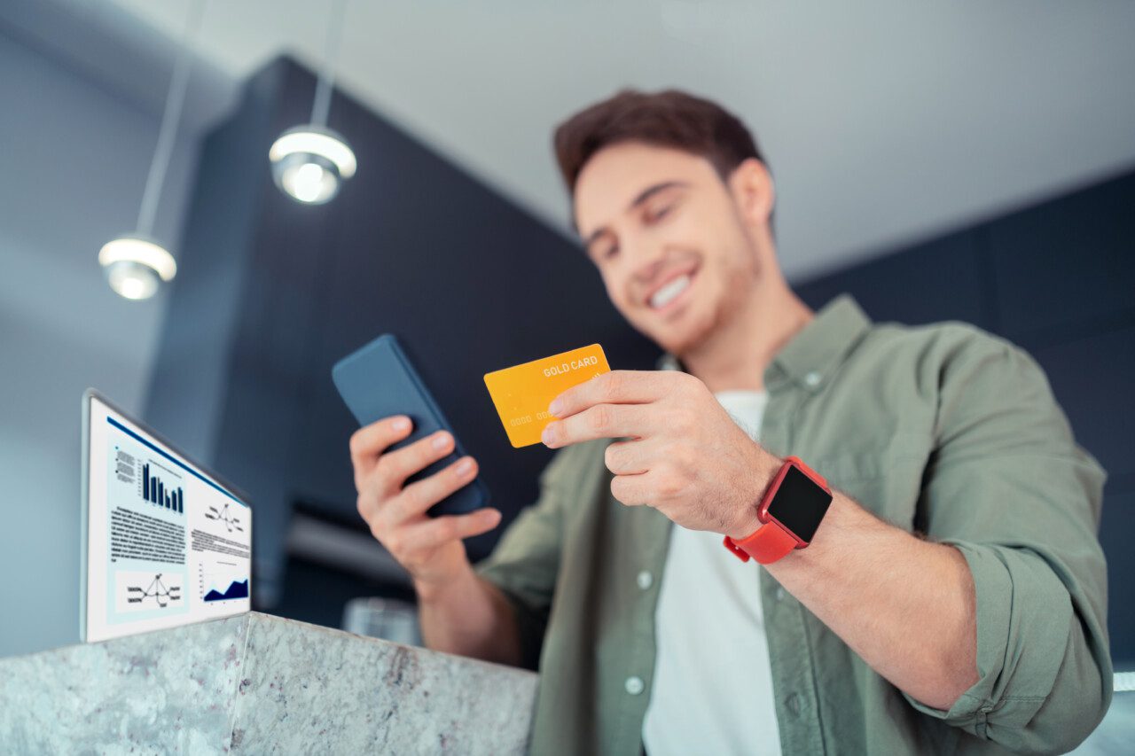 Close up of man holding bank card while shopping online banque en ligne crédit agricole